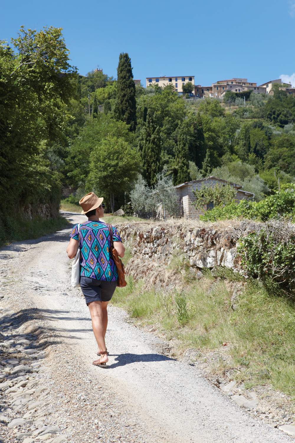 woman walking down a sunny path