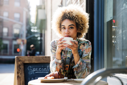 woman enjoying coffee break at a cafe