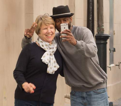 two people standing together, taking selfie