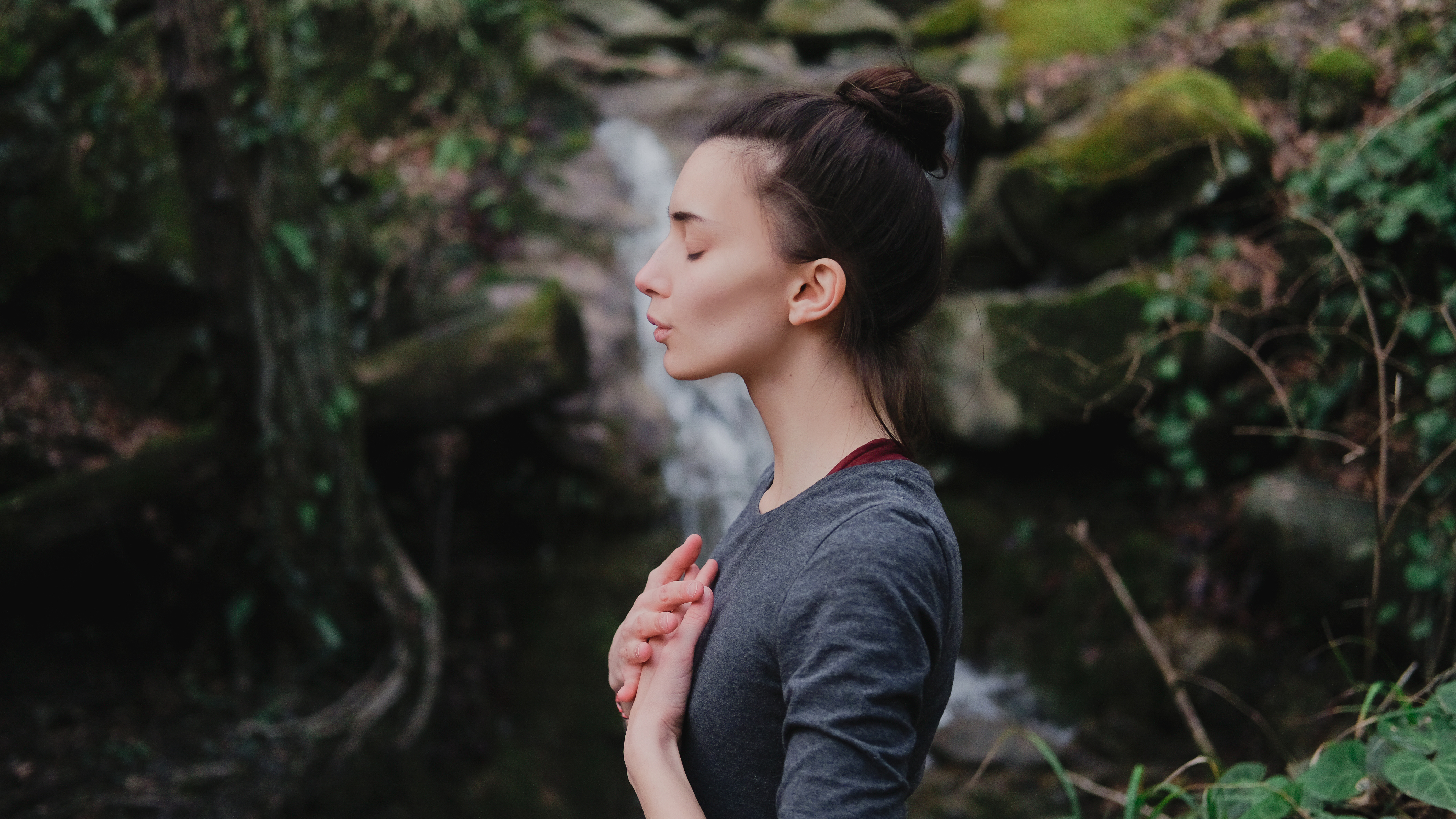 Is Breathing Connected to Free Will? - Woman breathing with eyes closed and hands on heart