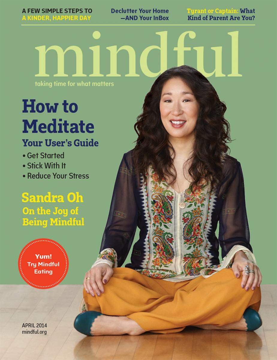 A woman with long, wavy hair sits cross-legged on the floor, smiling, on the cover of "Mindful" magazine's April 2014 issue. Headlines include "How to Meditate," "Sandra Oh on the Joy of Being Mindful," and other articles related to mindfulness and well-being.