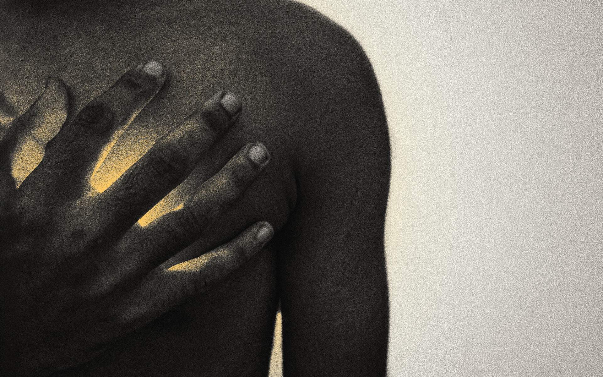 Young person with hand over their heart, which is glowing, exemplifying the strength of the Healing Breath practice.