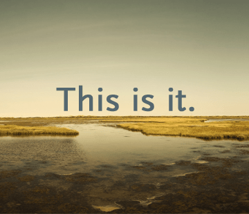 A serene landscape shows a tranquil water body surrounded by grassy marshes under a clear sky. Superimposed text in large, bold font at the center reads, 