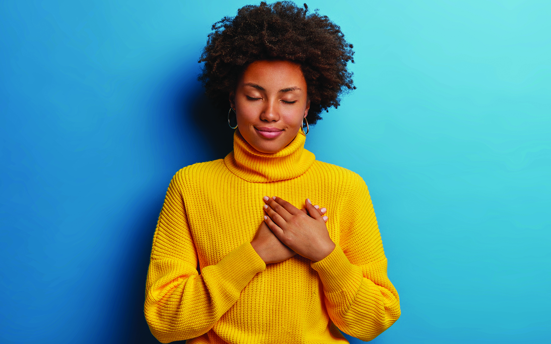 A Simple Meditation to Connect With Loving-Kindness - African American Women holds her hands over her heart