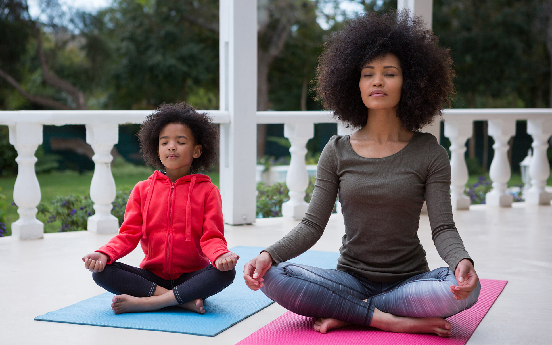 How You Can Help Others by Practicing Mindfulness- Mother and daughter meditating together on the porch