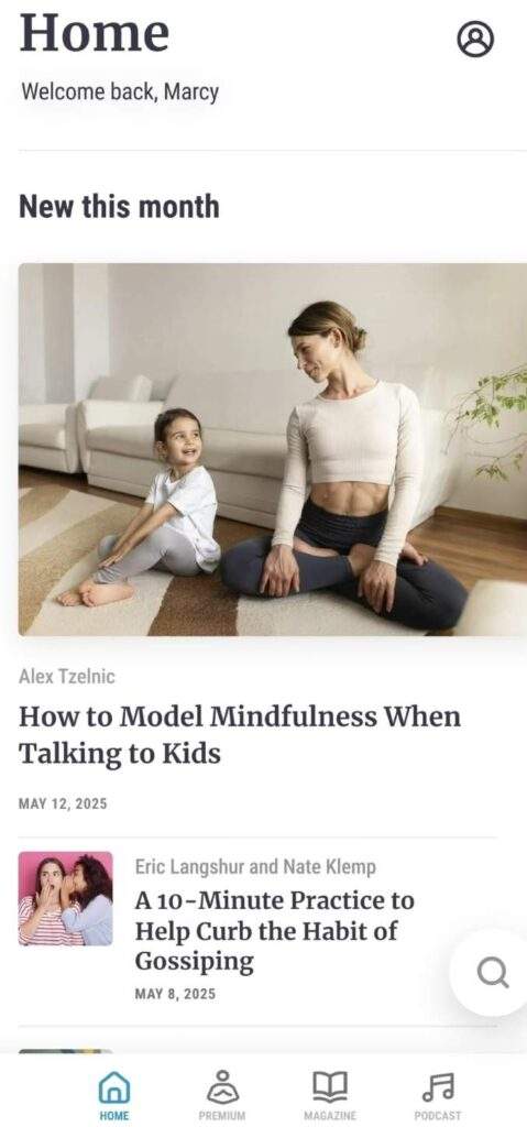 A mother and daughter sit on a yoga mat, smiling at each other in a bright living room after trying free meditation apps together.