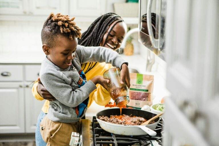 African American mother cooking with her son