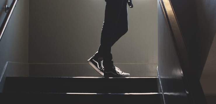 person on stairwell with light shining in