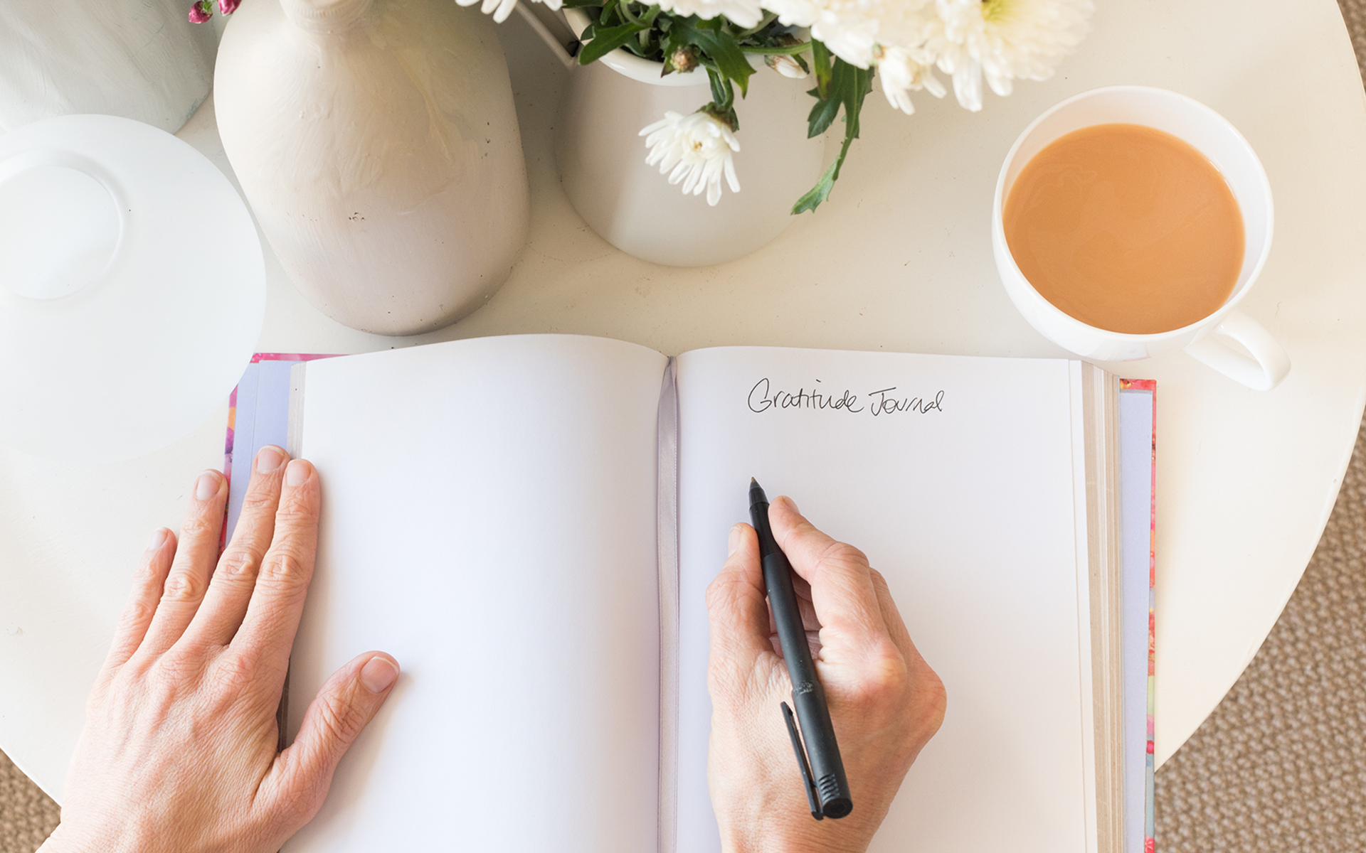 woman writing gratitude journal