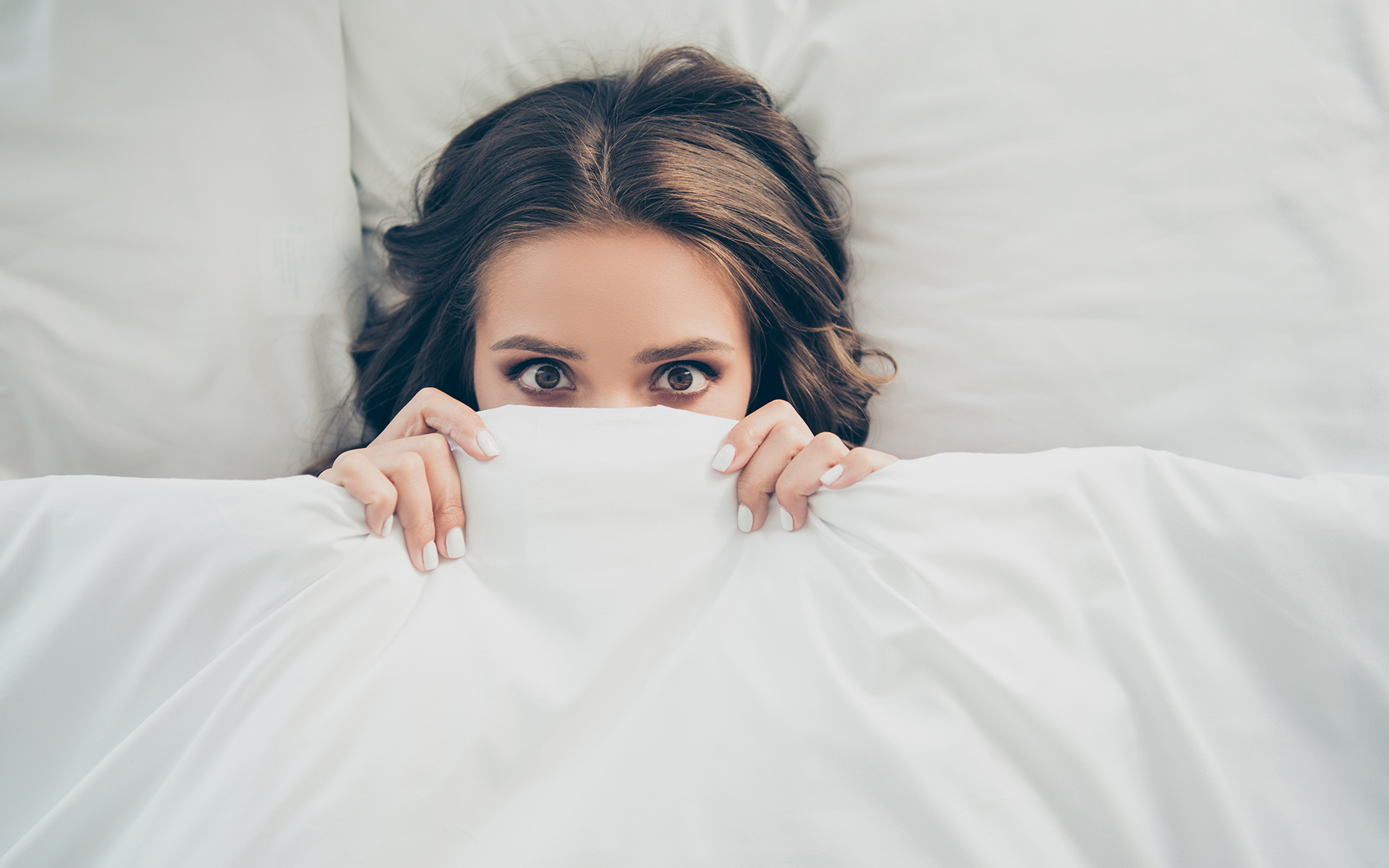 How Mindfulness Can Help You Navigate the Coronavirus Panic - Woman covering her face with a blanket in bed
