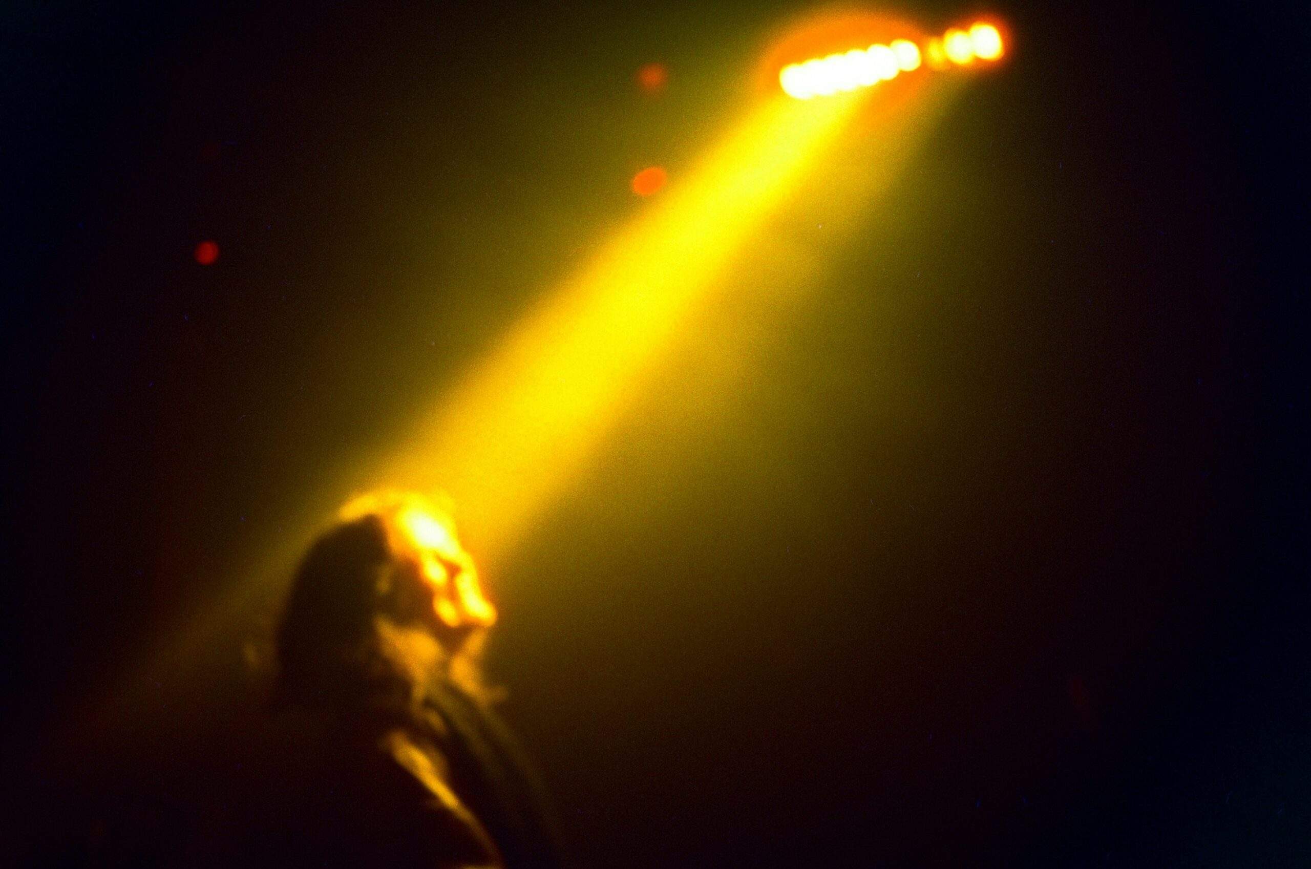 Woman in spotlight, as part of an essay on vanity and letting go.