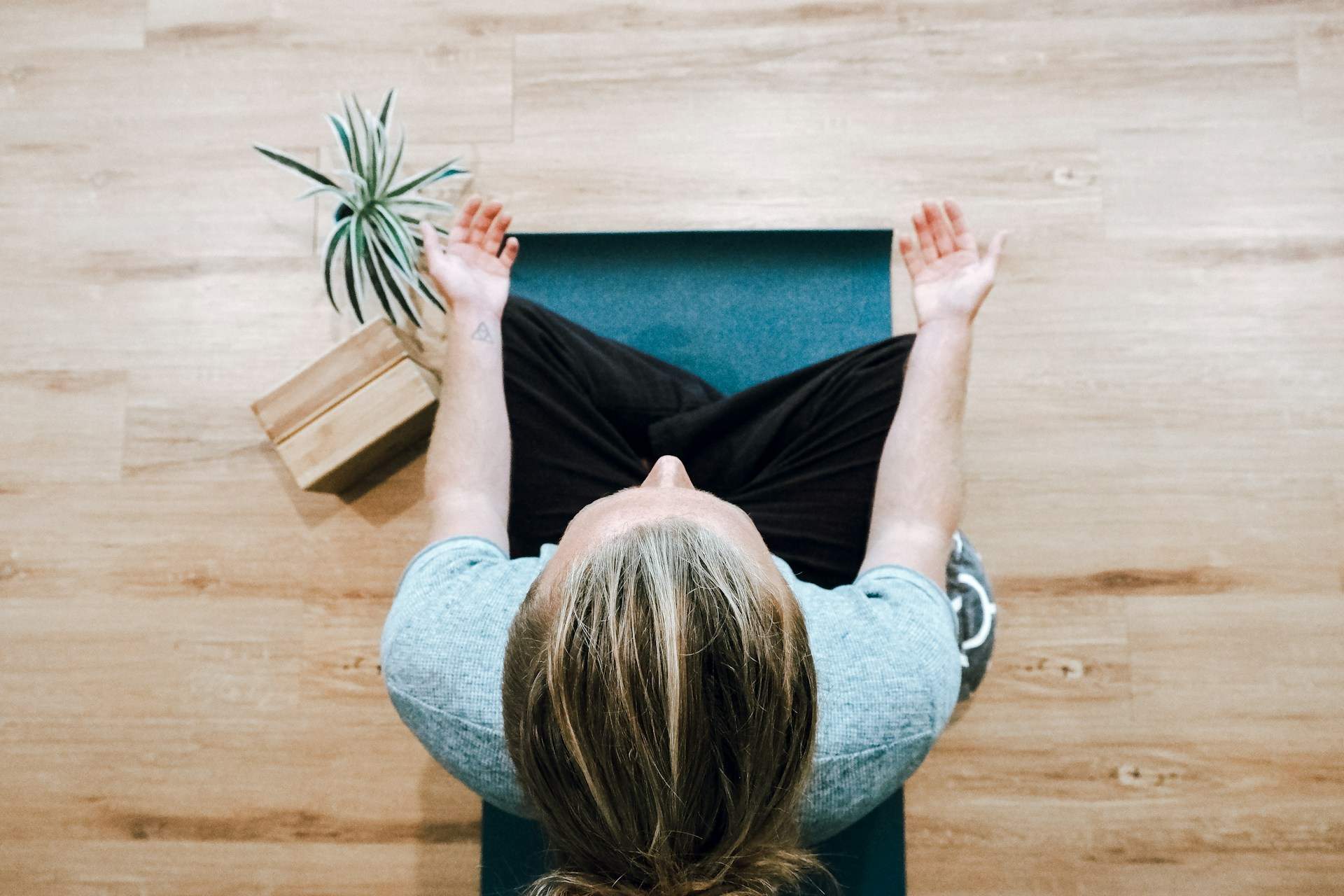 Woman sitting down and practicing mindfulness meditation