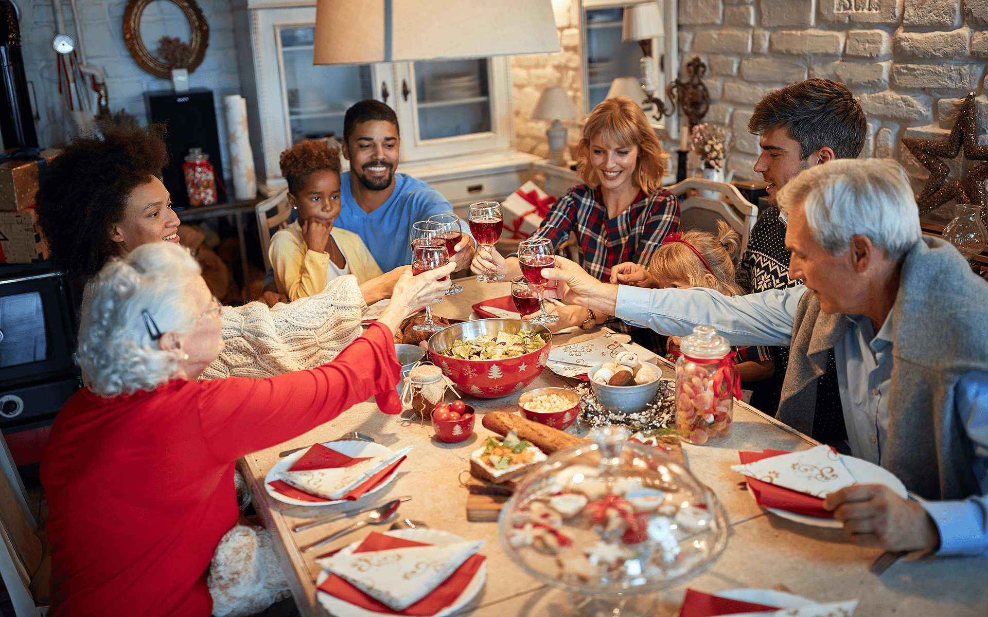 Photo of a family gathered around a table eating a holiday meal.