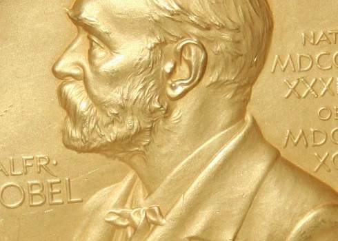 A gold medal with a portrait of a man.
