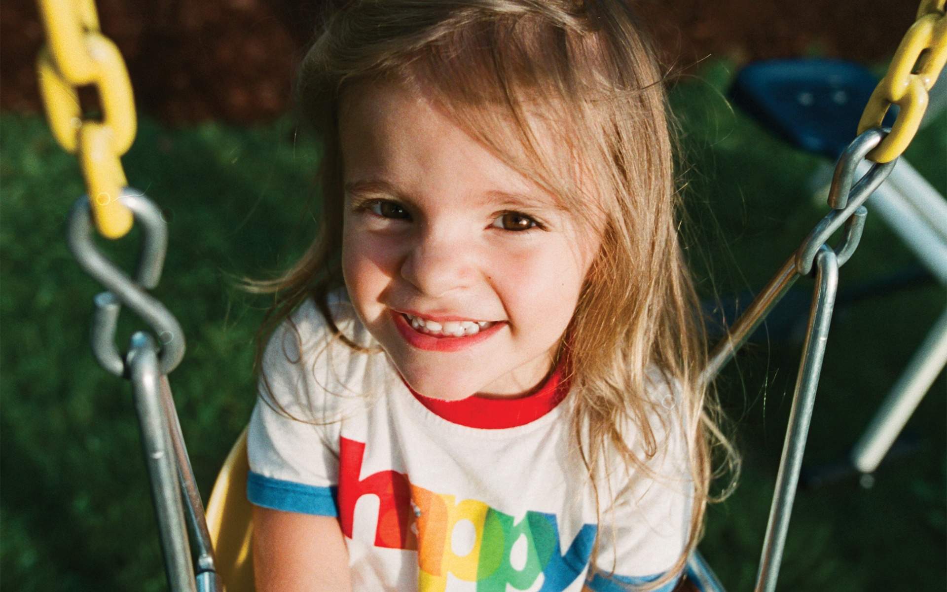 happy girl sitting on a swing