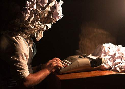 A man is typing on a typewriter.