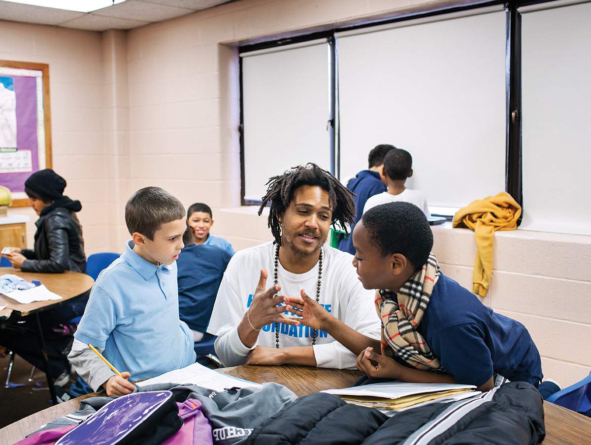 Atman Smith teaches Eric Denully, left, and Keon Burnett.
