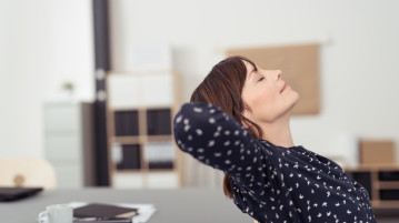 Three Simple Practices That Can Help Boost Happiness at Work woman relaxing at work