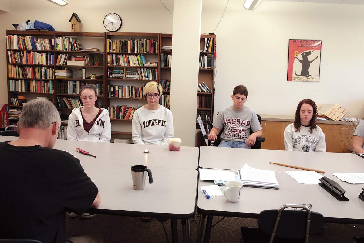 students take a moment of silence together after learning a hospice resident has died