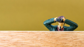 How Do I Get Noticed Around Here? miniature man looking through binoculars