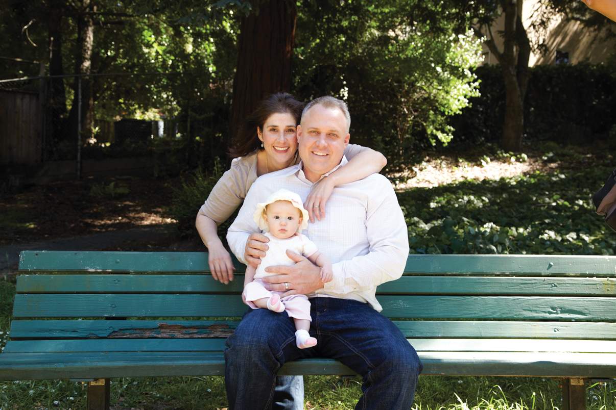 couple on bench with baby