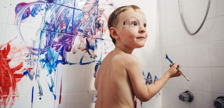 kid painting in the shower, looking super excited