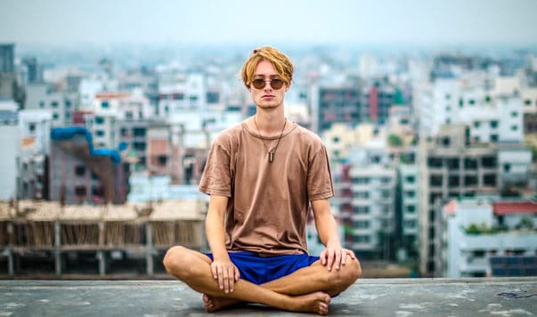 “Adult” Better with Meditation man meditating in city with sunglasses on