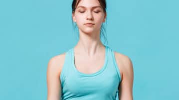 A 5-Minute Mindful Breathing Practice to Restore Your Attention woman meditating, eyes closed