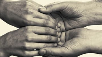 Let Go and Lean into Kindness with These Books and Podcasts pair of hands holding each other