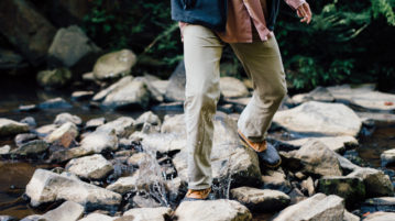 How Do I Bring More Mindfulness into My Life? man walking through rocks on hike, splashing up water