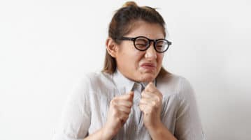 Embrace the Cringe of an Awkward Situation woman looking away, cringing
