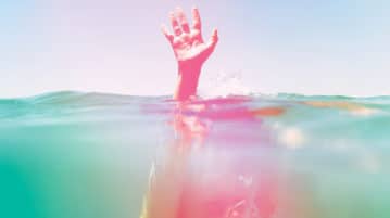 How Creativity Frees the Mind person under water, holding hand above watear