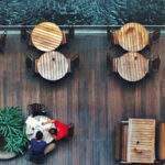 How to (Mindfully) Have an Awkward Conversation at Work two men sitting at table by waterfront