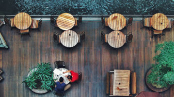 How to (Mindfully) Have an Awkward Conversation at Work two men sitting at table by waterfront