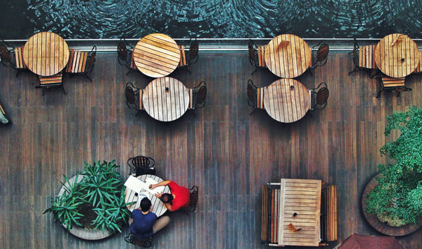How to (Mindfully) Have an Awkward Conversation at Work two men sitting at table by waterfront
