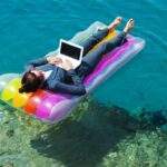 Quiz: Do You Feel Empowered at Work? woman on floating mattress with laptop on ocean