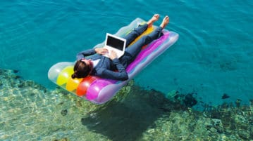 Quiz: Do You Feel Empowered at Work? woman on floating mattress with laptop on ocean