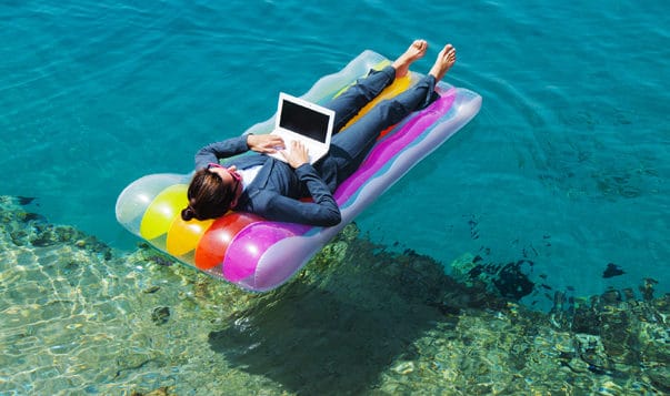 Quiz: Do You Feel Empowered at Work? woman on floating mattress with laptop on ocean