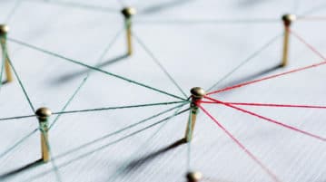 Three Simple Soft Skills to Make a Habit of at Work Thumbtacks linked together by red thread