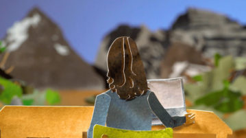 The Healing Power of Wild Places woman sitting at desk, facing Rocky Mountains