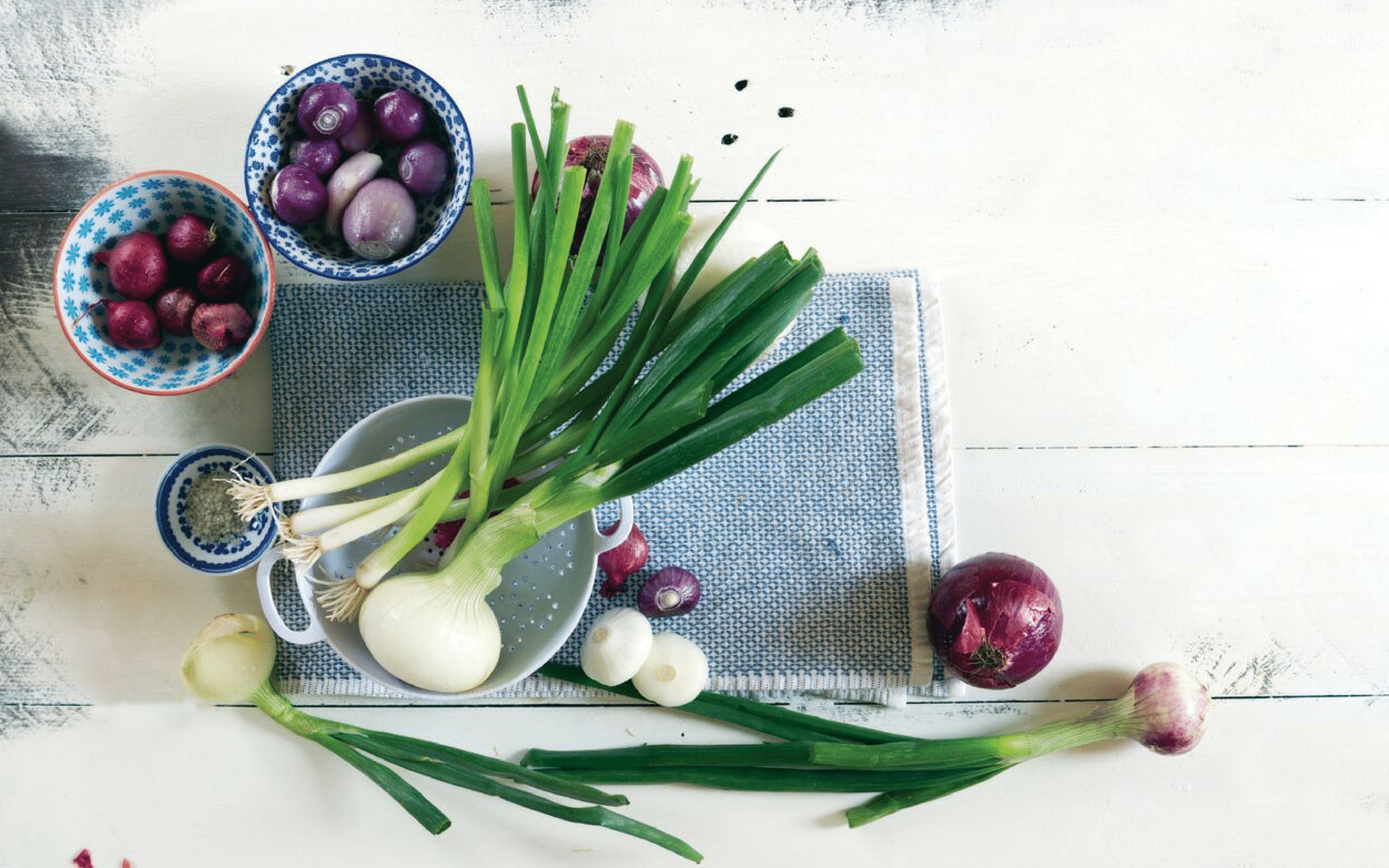 Table with bowls of fresh onions