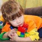 3 Ways to Inspire Kids to Share little boy keeps lego blocks to himself