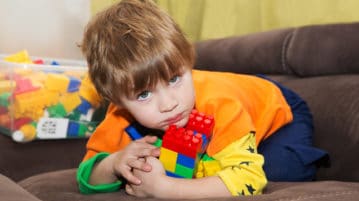 3 Ways to Inspire Kids to Share little boy keeps lego blocks to himself