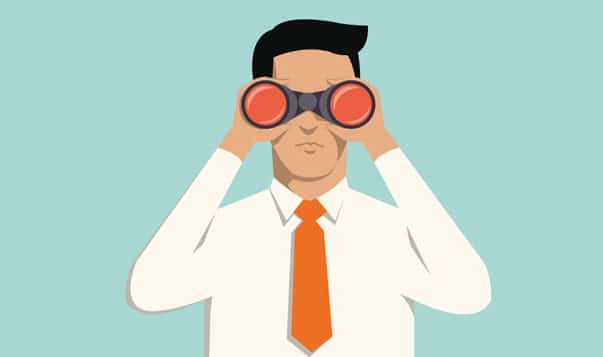 How to Avoid Confirmation Bias at Work man in suit with binoculars