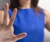 woman holding up hand to say "No"