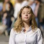 How To Meditate with Noise: A 3-Minute Practice for Anywhere woman meditating in public