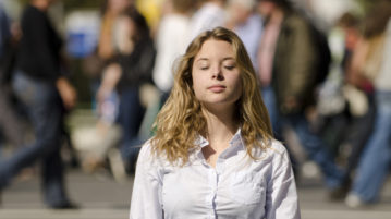 How To Meditate with Noise: A 3-Minute Practice for Anywhere woman meditating in public