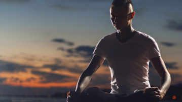 Mindfulness: An Innate, Trainable Quality of Mind man meditating outdoors at sunset