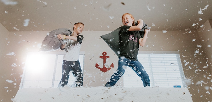 children having a pillow fight