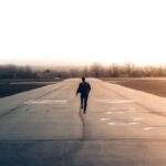 man walking down airport runway